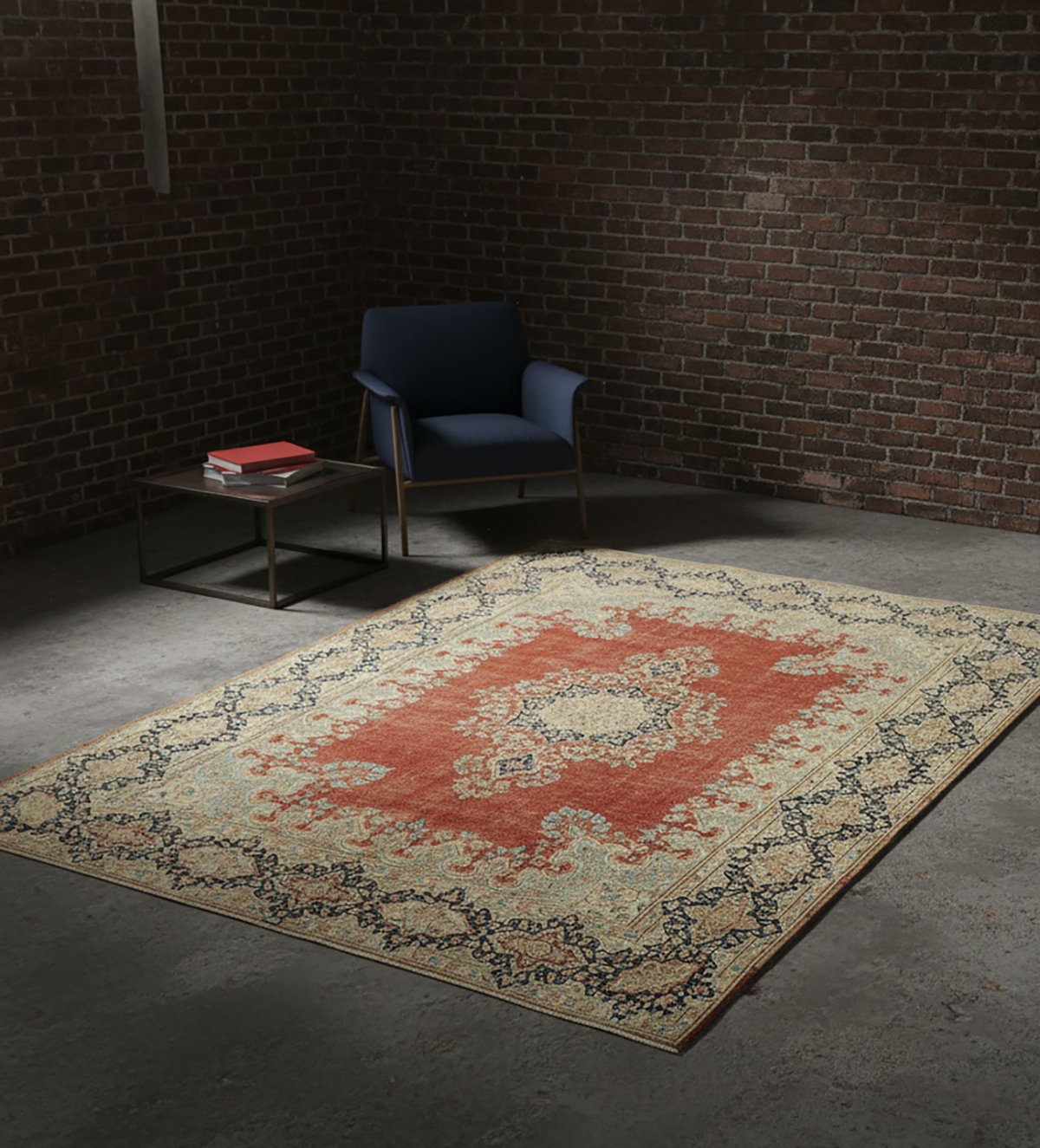 Proper placement of a large 8x10 vintage area rug under a modern sectional sofa and coffee table, demonstrating the 'anchor' rule for defining a cozy, cohesive living room gathering space.
