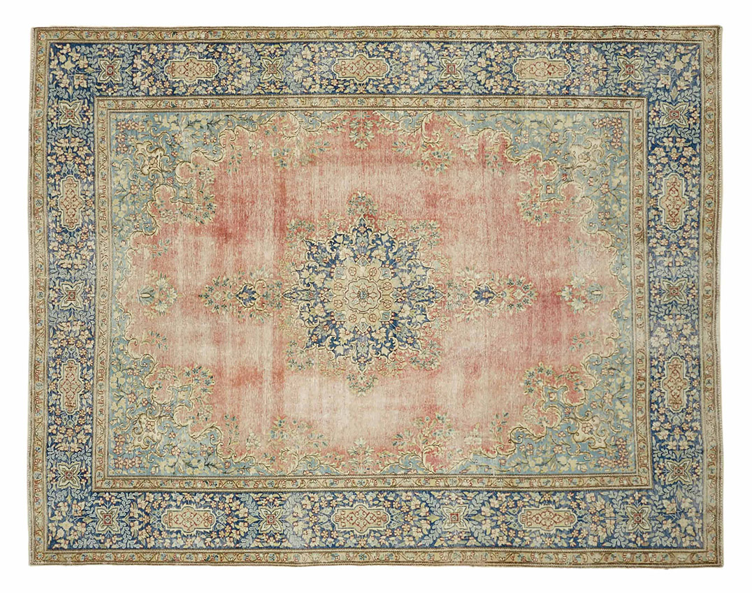 Vintage Persian rug with a faded pink and beige field, intricate central medallion, and floral blue borders – hand-knotted wool large area carpet.