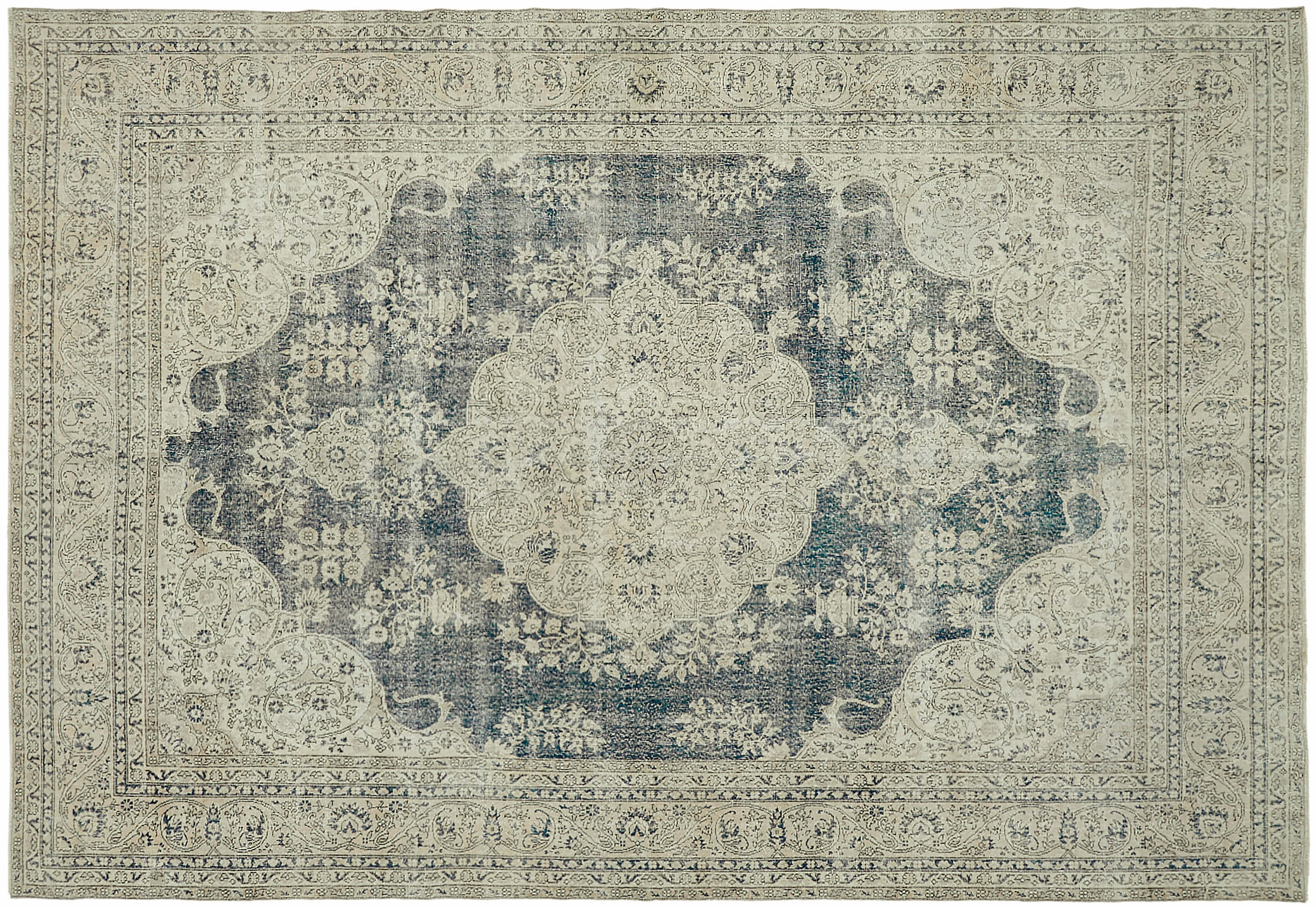 Detailed image of a traditional Turkish style vintage rug. The layout features a central medallion design with intricate floral and geometric patterns. The color palette of the rug includes shades of blue, gray and beige, giving it an old and distressed look. The border is adorned with repeating motifs and ornate designs that add to the overall complexity and elegance of the piece. The craftsmanship is evident in the fine details and symmetrical patterns throughout the rug.