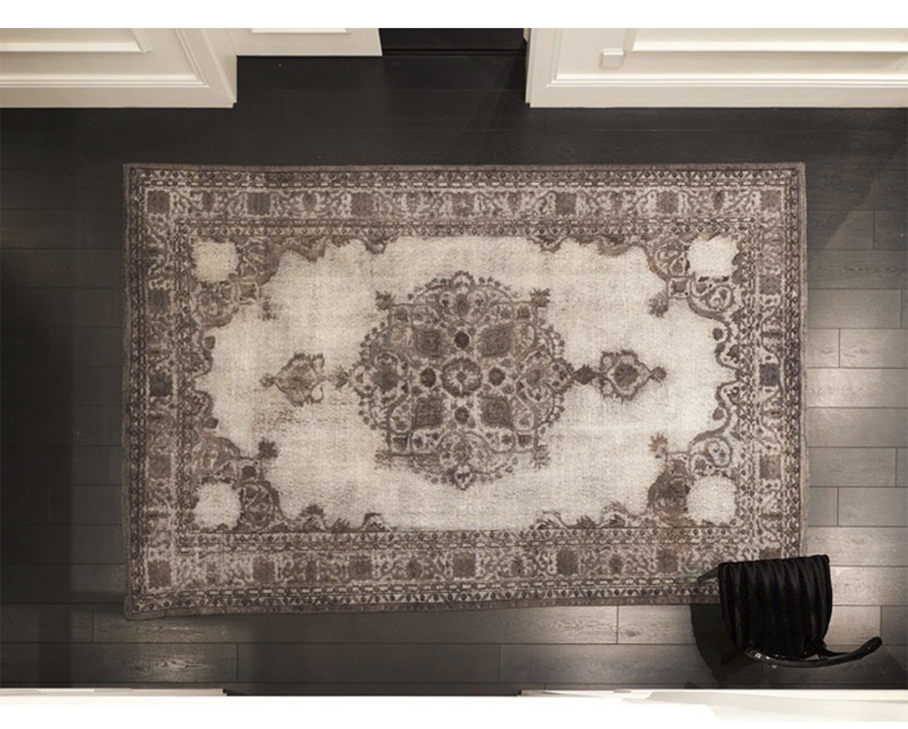 A serene contemporary interior featuring a textured natural handwoven rug, bringing organic warmth and tactile richness to a minimalist design scheme.