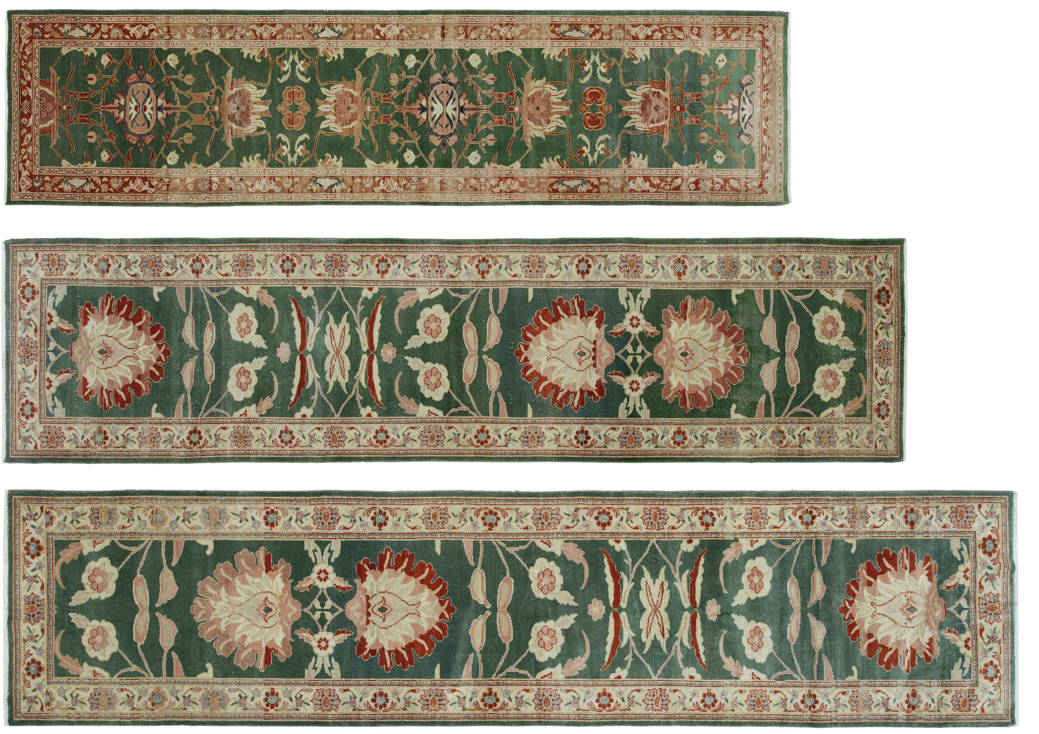 Three rectangular Turkish oushak runner carpets in traditional style with intricate floral patterns. Each carpet has a dominant green background with intricate patterns in shades of red, beige and cream. The carpets are laid horizontally with the largest at the bottom and the smallest at the top. The borders feature symmetrical floral motifs, including large central flowers and smaller surrounding elements. The edges are finished with a subtle beige trim that enhances the overall elegance. The design is consistent across all three rugs and displays a harmonious blend of colours and patterns typical of classical carpet art.