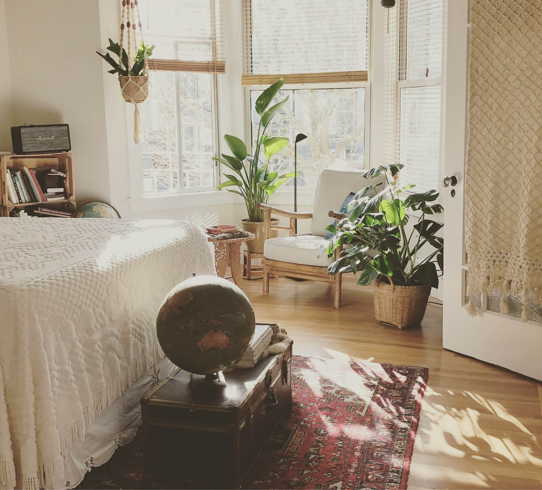 This bedroom highlights the sophisticated appeal of a red 6x9 rug. The space is decorated with furniture and décor that complement the rug, and warm lighting creates a comfortable and inviting atmosphere.