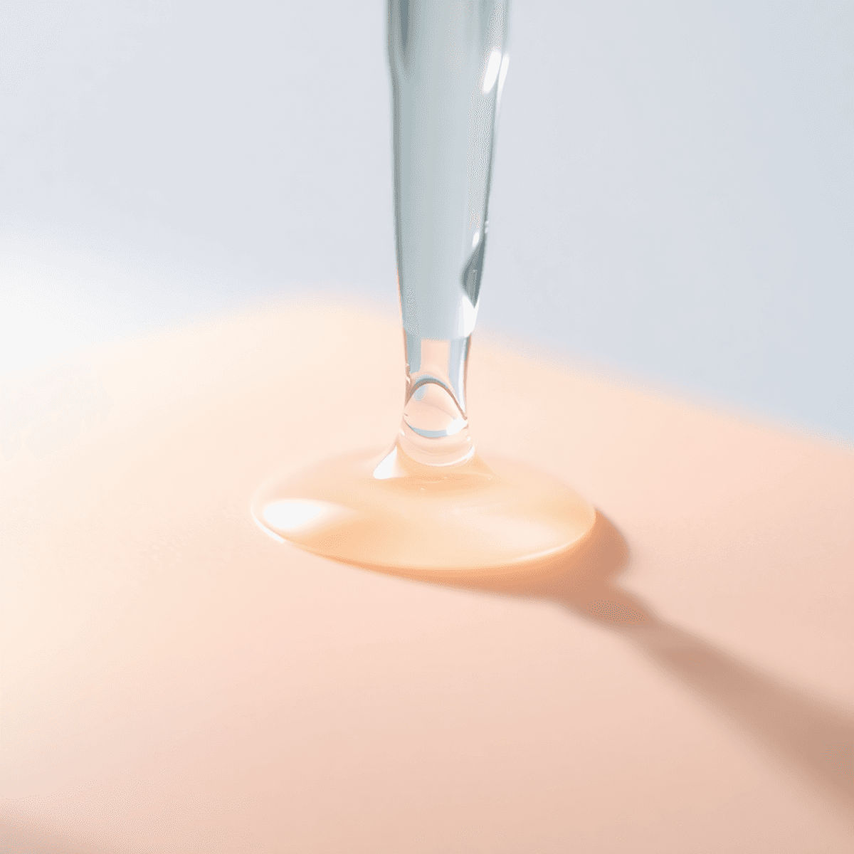Korean PDRN Serum Guide: 6 Best Picks + What to Avoid 1 Close-up of a serum dropper releasing glowing liquid onto smooth, radiant skin with light reflections, set against a soft pastel background.