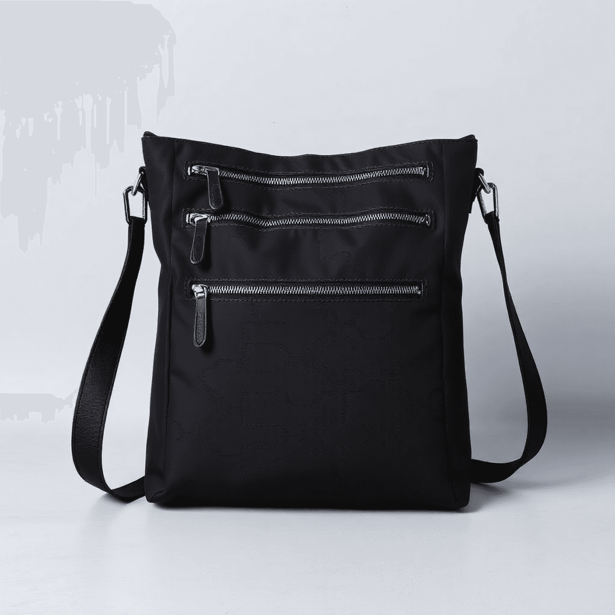 A stylish nylon hobo shoulder bag in subtle tones, displayed against a minimalist background, featuring premium metal hardware and smooth zipper pulls.