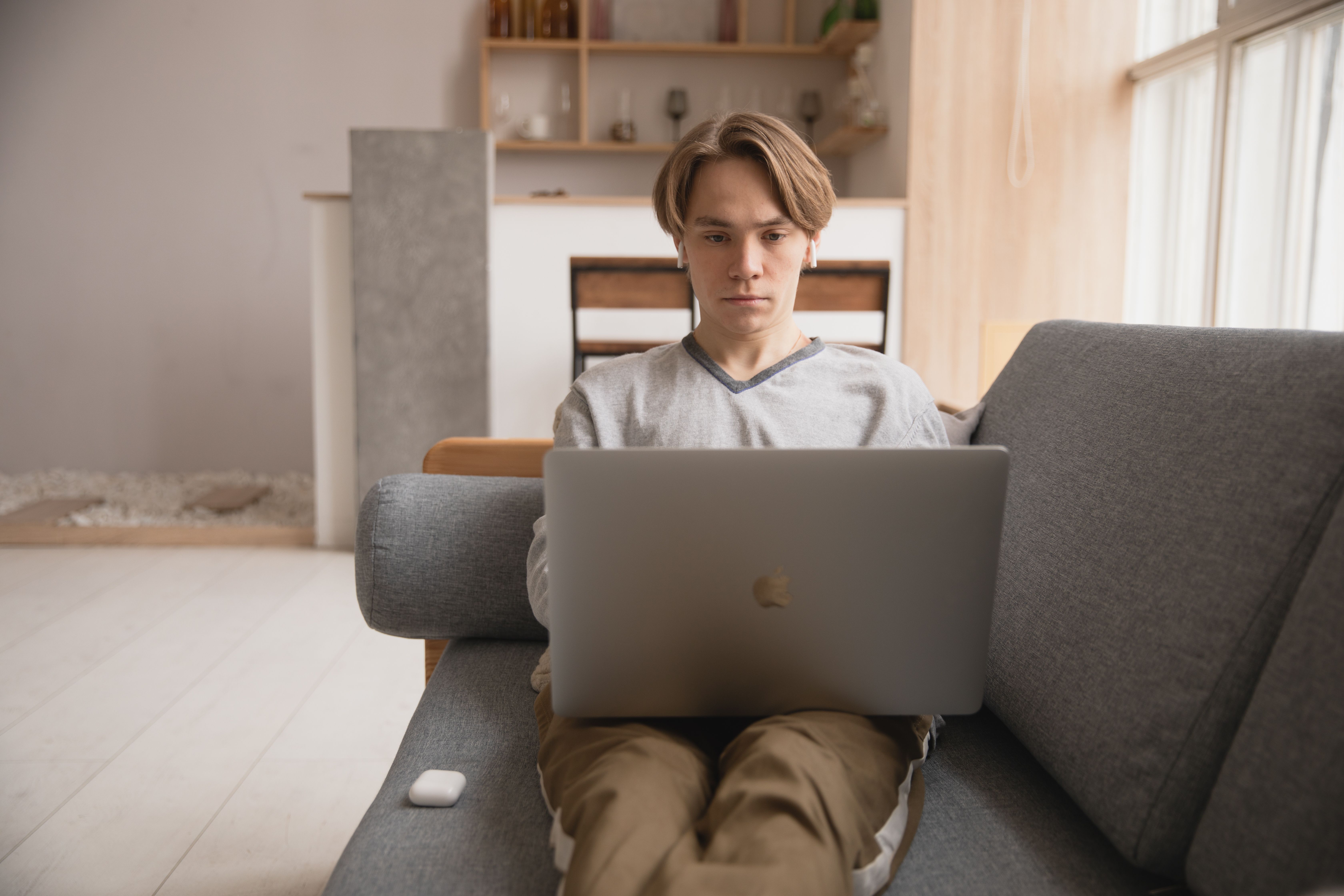 Job seeker reviewing skills for a resume on a laptop at home