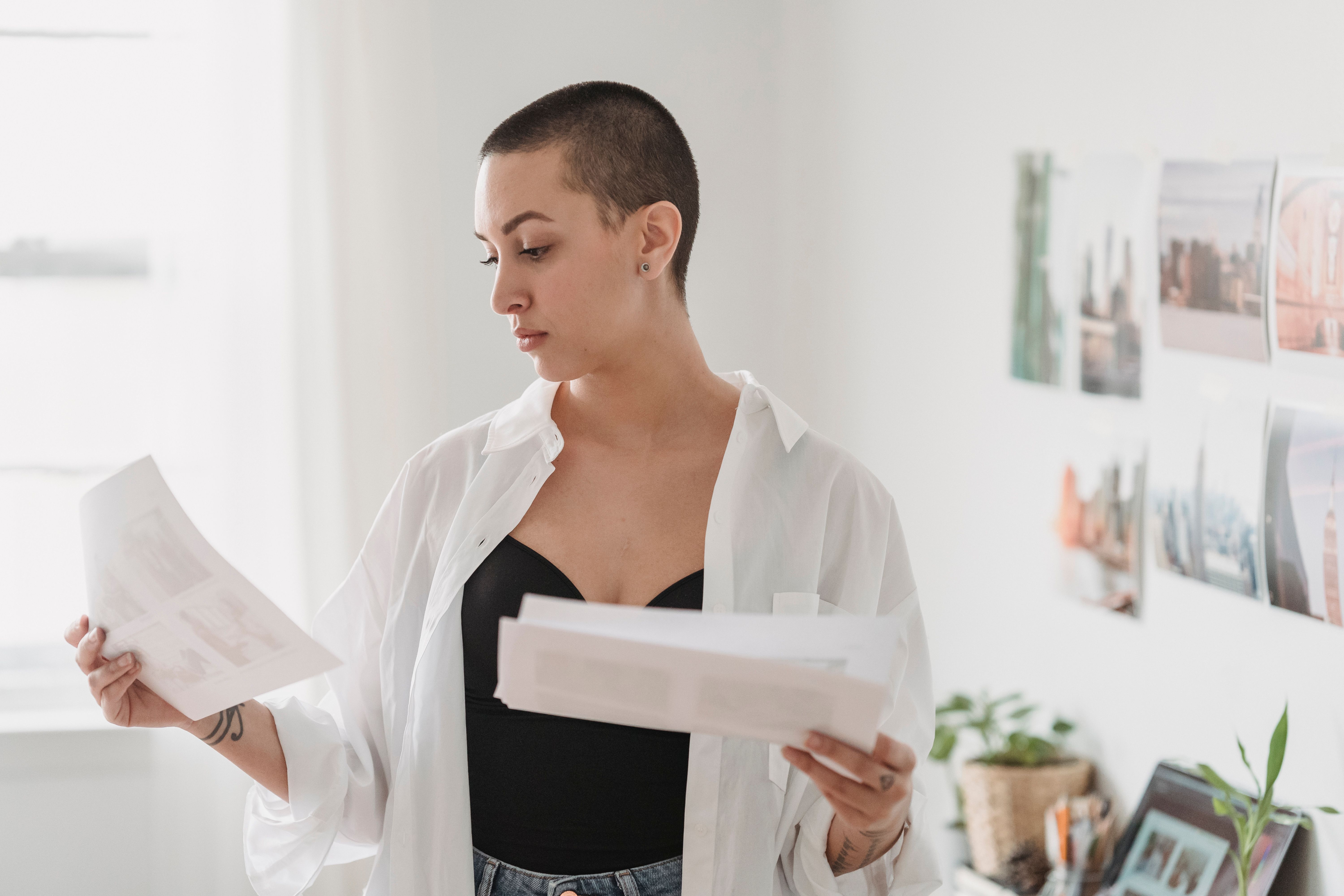 Person reviewing household bills and paperwork in a kitchen