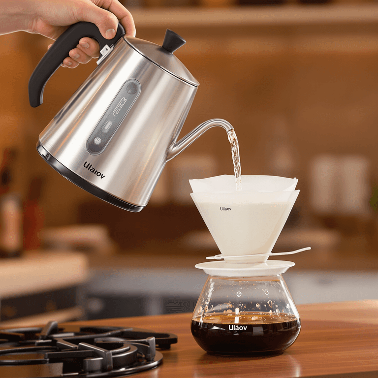 Ulalov Electric Kettle A sleek electric kettle with a gooseneck spout pouring hot water over a pour-over coffee dripper in a cozy kitchen setting.